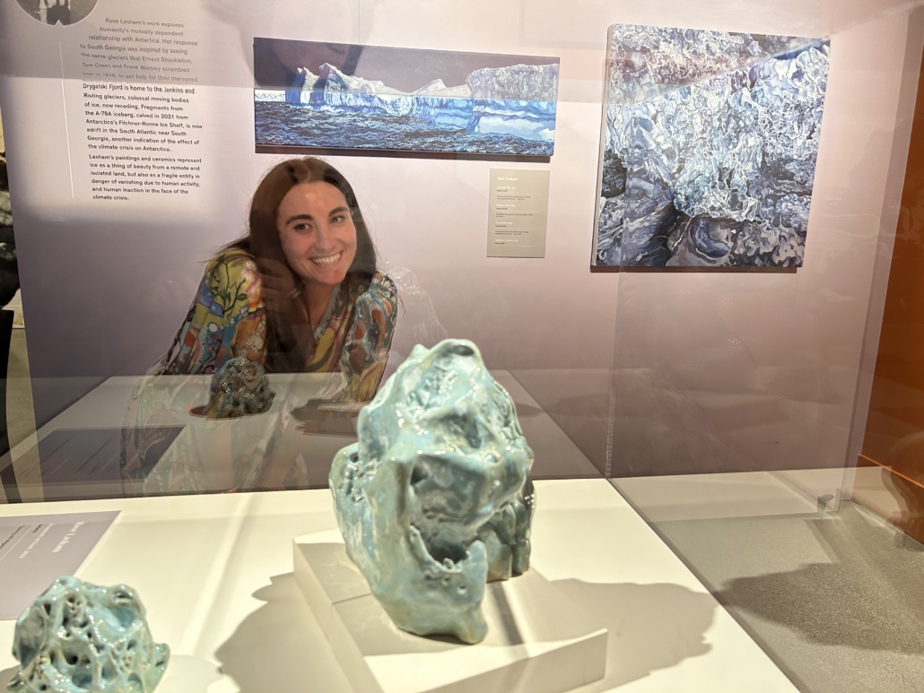 Rose Lasham with the ceramic sculptures and paintings she created for an art exhibition group outreach project hosted by the New Zealand Maritime Museum.